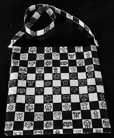 Tote bag with black and white grid and Taino symbols